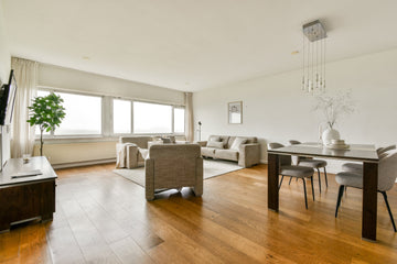 Bright open living and dining room with warm wood-look plank flooring | Oakel City